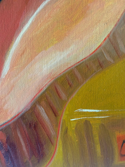 Close-up of an abstract painting with warm colors and textured surface.
